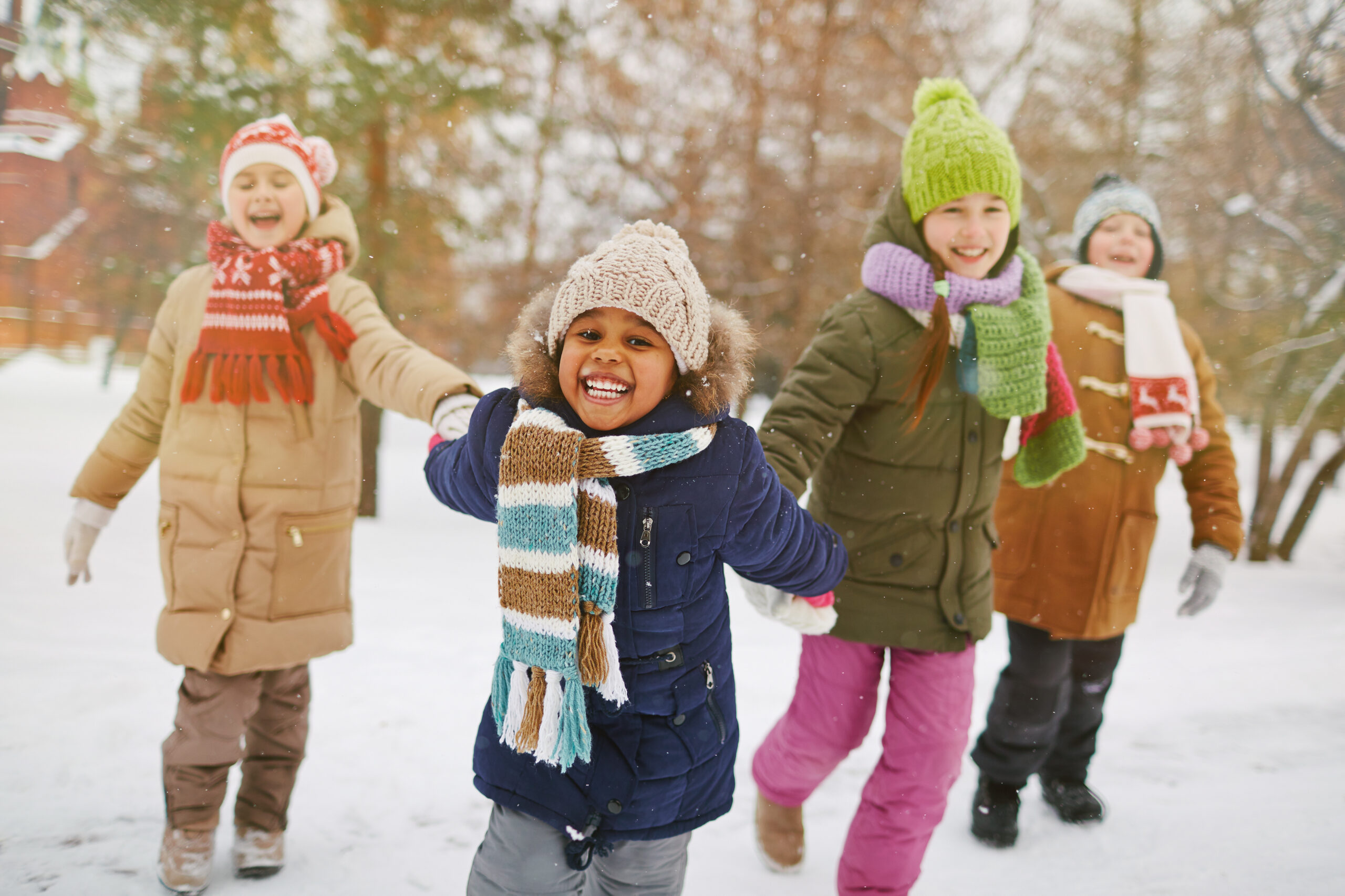 Cheerful girl looking at camera with her friends on background